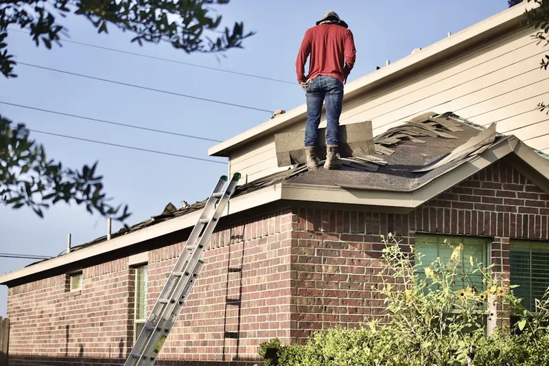 Professional roofer working on a residential roof in Victory Lakes